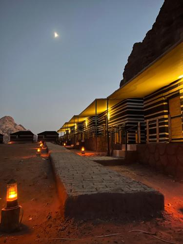 a building with lights on the side of it at RUM STARDUST lUXURY CAMP in Wadi Rum