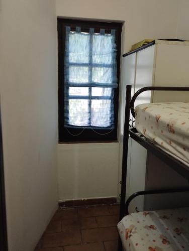 a room with a window and a bunk bed at casa vacanze Cettina home 2 mt 50 dal mare in Terra Mala