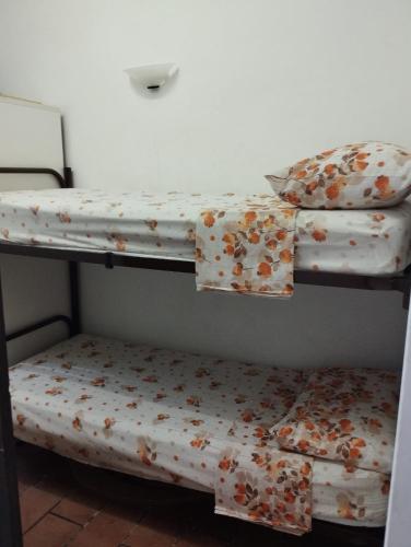 two bunk beds sitting next to each other in a room at casa vacanze Cettina home 2 mt 50 dal mare in Terra Mala