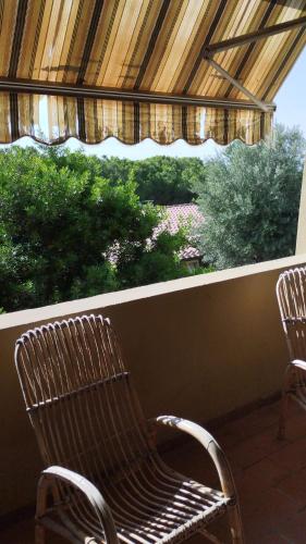 a bench sitting in a porch with a window at casa vacanze Cettina home 2 mt 50 dal mare in Terra Mala