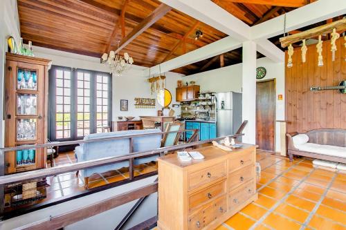 a large kitchen with wooden ceilings and a table at The Cats' House in Florianópolis