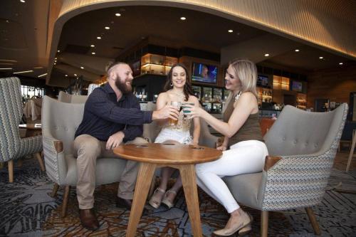 a group of people sitting at a table in a restaurant at Special VIP Mariott Apartment in Baku