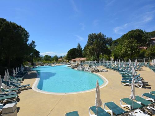 une grande piscine avec des chaises et des chaises de jardin dans l'établissement Maison Duplex avec Terrasse - 6 Pers, 4 Pièces, WiFi, Animaux Bienvenus, Parking Inclus - FR-1-382-185, à Grospierres