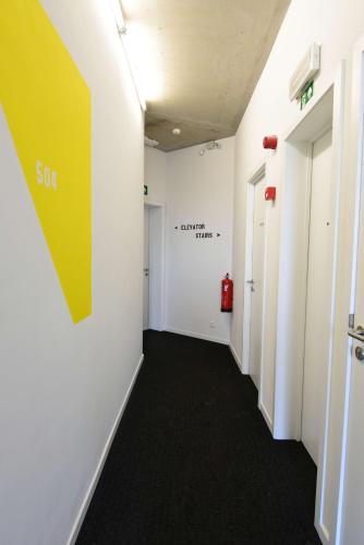 a hallway in an office with a yellow sign on the wall at Hôtel Belvue in Brussels