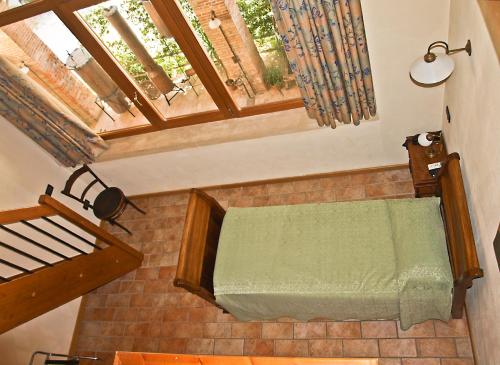 an overhead view of a bed in a room with windows at Agriturismo Il Palazzone in Montegalda