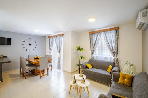 a living room with a couch and a table at Estrena casa a minutos del aeropuerto in Monterrey