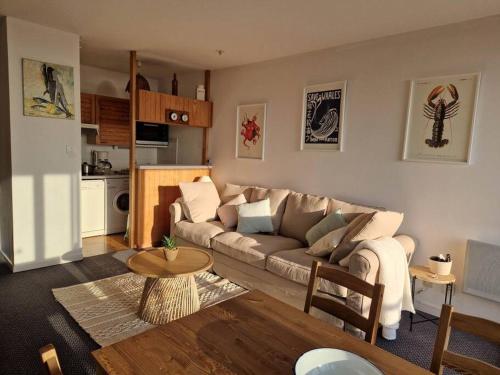 - un salon avec un canapé et une table dans l'établissement Appartement aux Minimes Magnifique Vue Mer au pied de la Plage 50m2-2ch., à La Rochelle