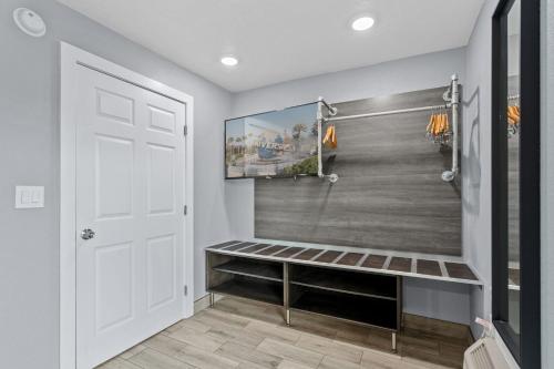 a walk in shower with a bench next to a door at Celebration Suites in Orlando