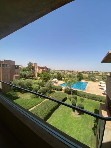 a view of the garden from the balcony of a building at Que du love in Marrakesh