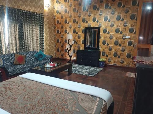 a living room with a couch and a table at Royal Luxury Hotel Lahore in Lahore