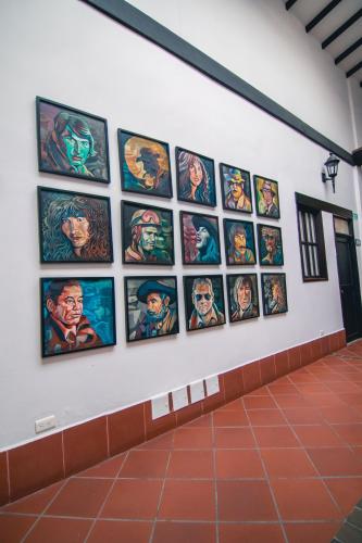 a wall of superheroes paintings on a wall at Hotel Boutique San Antonio in Cali