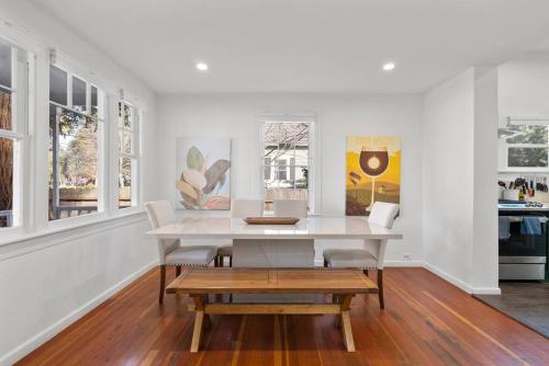 a white dining room with a table and chairs at Downtown Napa HOT TUB Retreat - 3 Bed l 2 bath in Napa