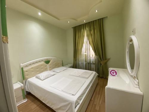 a small bedroom with a white bed and a window at LARGE 5 BEDROOM LUXURY VILLA in Yerevan