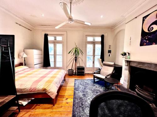 a bedroom with a bed and a fireplace at Paul’s Boutique in Sydney