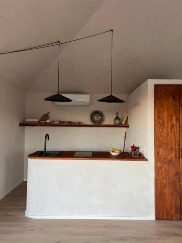 a kitchen with three lights hanging from the ceiling at Casa Otea in Ávila