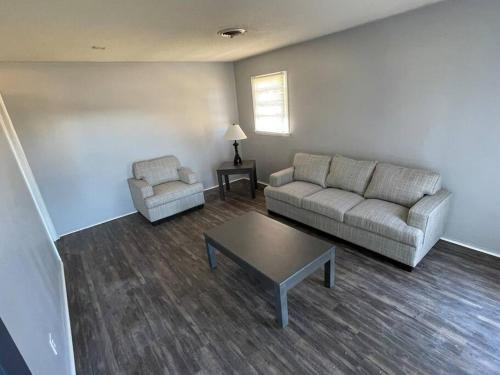 a living room with a couch and a coffee table at Cozy 4 Bedroom Near Airport in Montgomery