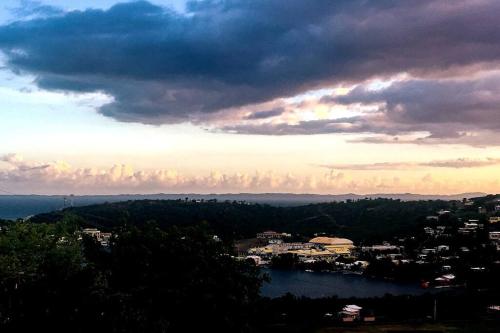 a view of a city and the water with a cloudy sky at Casa Carmen Culebra- Gibraltar in Culebra