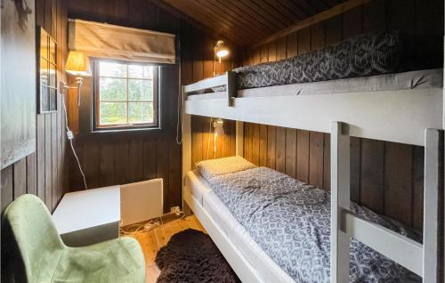 a bedroom with two bunk beds and a chair at Pet Friendly Home In stby With Wifi in Østby
