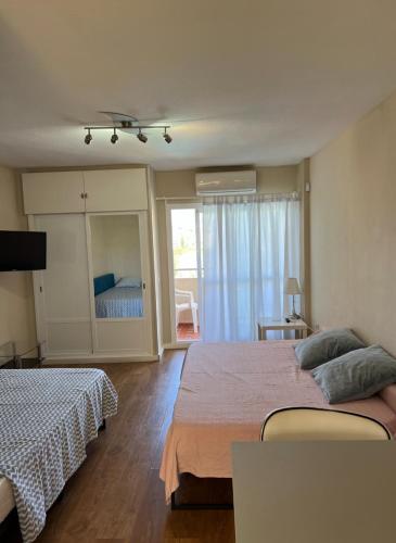 a bedroom with two beds and a sliding glass door at Jupiter Sea View in Benalmádena