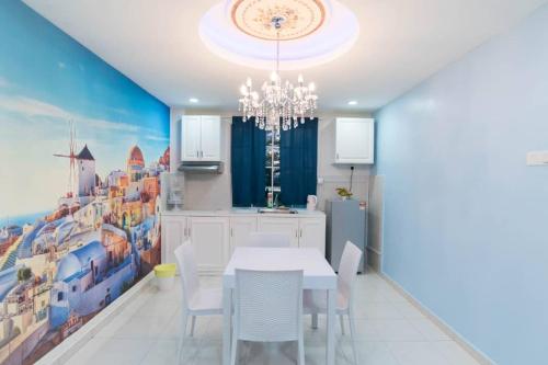 a dining room with a white table and a chandelier at The Trails of Kampar in Kampar