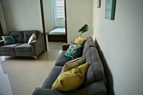 a living room with a couch with pillows at Casa Carmen Culebra- Suez in Culebra