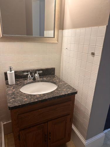 a bathroom with a sink and a mirror at Dover Historic Building 1Bed w/Hot Tub 1st floor in Dover