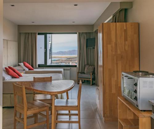 a hotel room with a table and a dining room at Miralejos in Ushuaia