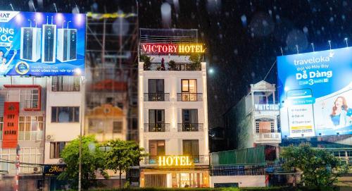 a building in a city in the rain at Victory Hotel in Hanoi