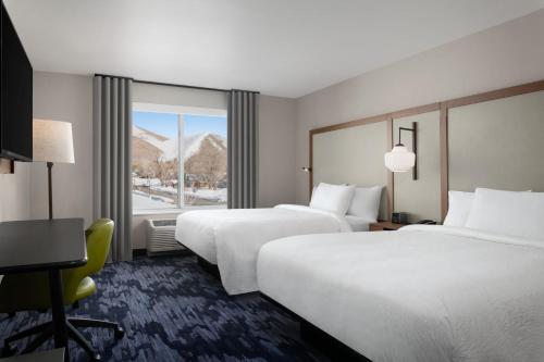 a hotel room with two beds and a window at Fairfield by Marriott Inn & Suites Hailey Sun Valley in Hailey