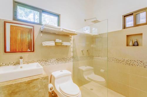 a bathroom with a toilet and a sink and a shower at Stay in the Heart of Tulum - best location in Town in Tulum