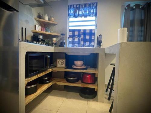 a kitchen with a counter with a microwave and a kitchen at Rota- Casa Carmen Culebra in Culebra