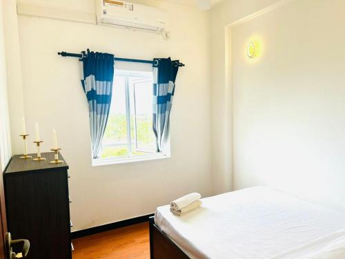 Ένα ή περισσότερα κρεβάτια σε δωμάτιο στο Aeonsky apartment Negombo beach and airport