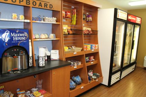 a coffee shop with a counter in a store at Candlewood Suites Washington-Dulles Herndon by IHG in Herndon