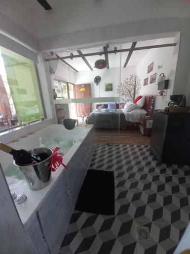 a kitchen with a checkered floor and a living room at La Bota del Gigante in Gigante