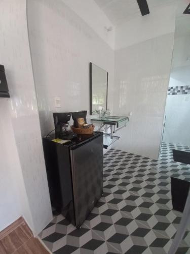 a bathroom with a black and white checkered floor at La Bota del Gigante in Gigante