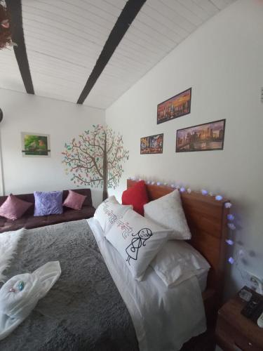 a bedroom with a large bed with many pillows at La Bota del Gigante in Gigante