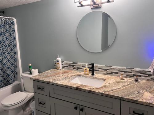 a bathroom with a sink and a mirror at Petit Domicile QUEEN & TWIN Beds Main Floor in Lincoln