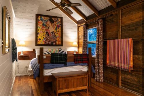 a bedroom with a bed and a ceiling fan at Luxury Cabin Bawley Ridge Farm, dog friendly in Termeil
