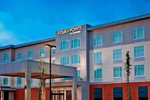a building with a sign on the side of it at Four Points by Sheraton Edmonton International Airport in Nisku