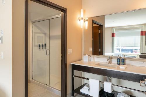 a bathroom with a sink and a shower at Four Points by Sheraton Edmonton International Airport in Nisku