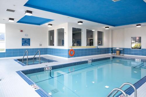 a pool with a blue ceiling and blue tiles at Four Points by Sheraton Edmonton International Airport in Nisku