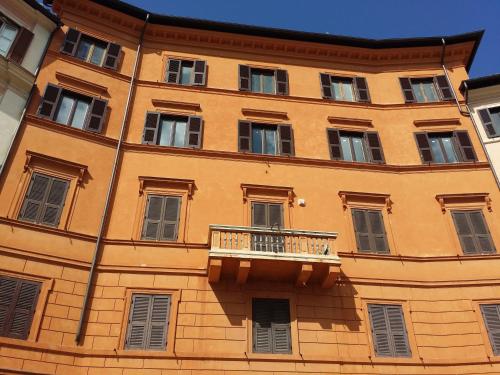 a large orange building with a balcony on it at Navona 49 Luxury Suites&Apartment in Rome