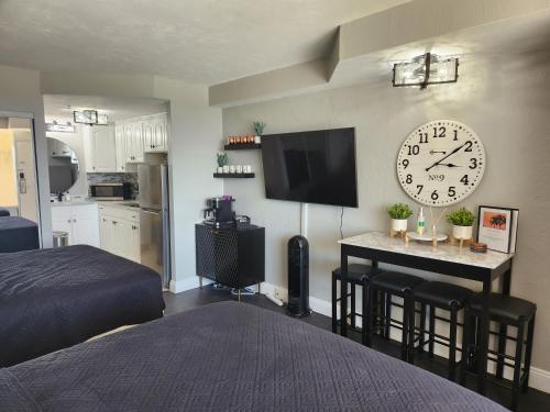 a bedroom with a large clock on the wall at Modern Beach Condo-Daytona Beach in Daytona Beach