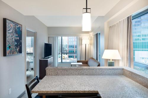 a living room with a couch and a table in a room at Residence Inn by Marriott Boston Back Bay/Fenway in Boston