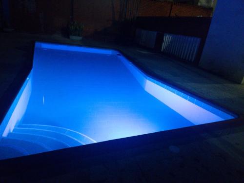 a swimming pool with blue lighting in a dark room at El Rincón de Granada Hotel in Cali