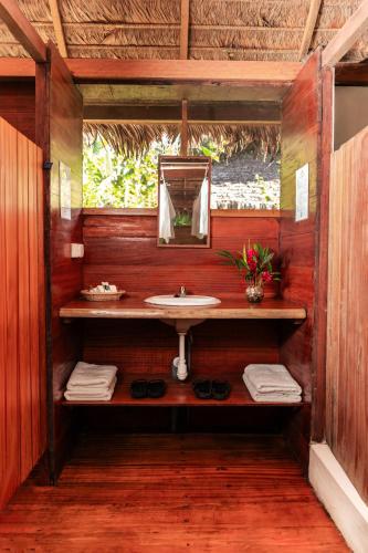a bathroom with a sink and a mirror at Ecolucerna Lodge Tambopata in Puerto Maldonado
