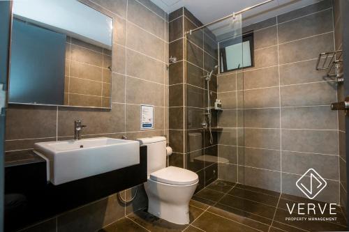 a bathroom with a toilet and a sink and a mirror at Ipoh Tambun Lost World Onsen by Verve in Tambun