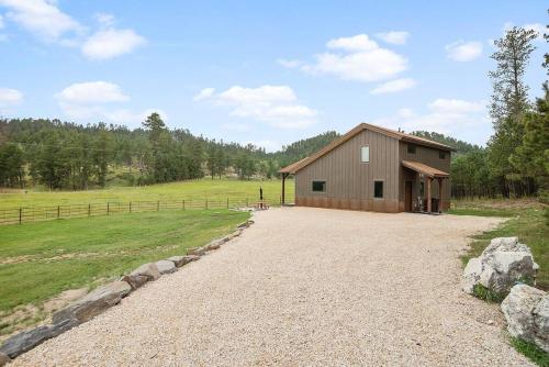 a barn with a gravel driveway in front of it at Hot Shot Hideaway in Custer