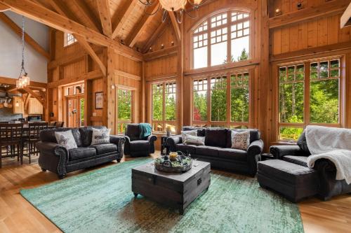 a large living room with wooden walls and a large ceiling at Maple Hill Lodge home in Stevenson