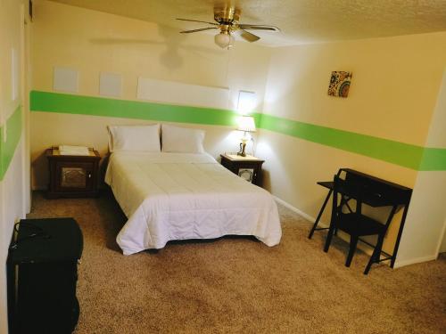 a bedroom with a bed with a green stripe on the wall at Golden Sunflower's Apt E in Lawton